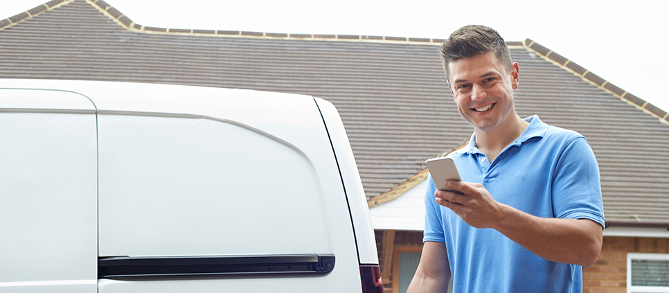 man by van checking phone image