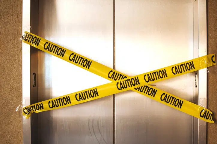 out of service elevator with caution yellow tape