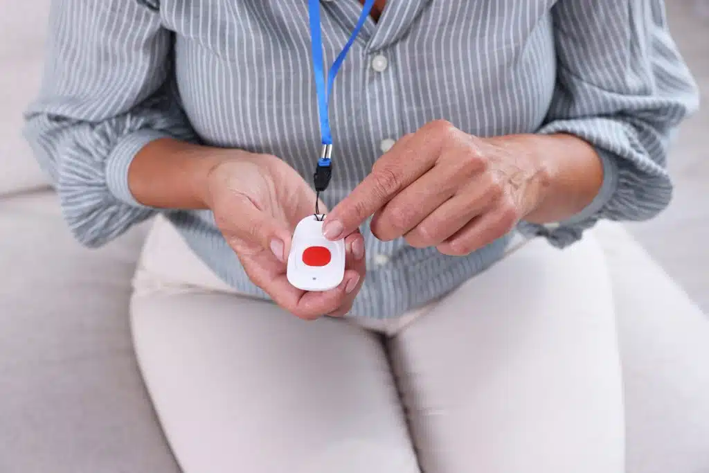 woman pointing at emergency button for life critical image
