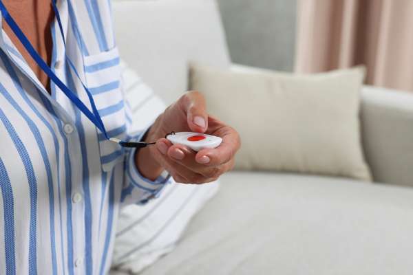 woman pressing emergency response button image