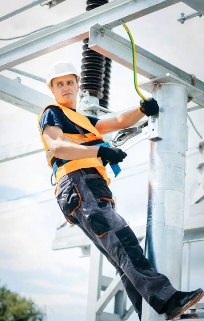 workman in hi-vis on building image
