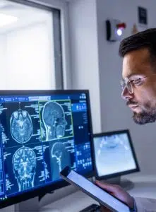 doctor on tablet with pc monitor checking scans image