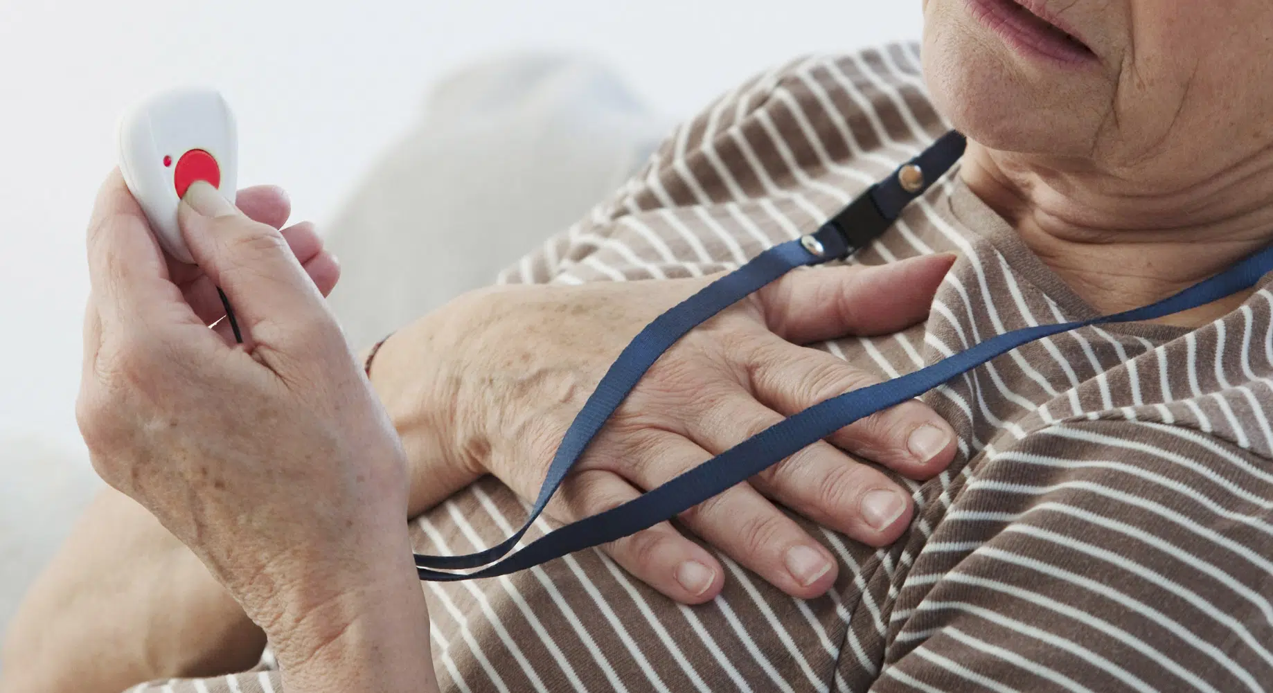 senior woman pressing emergency panic button image