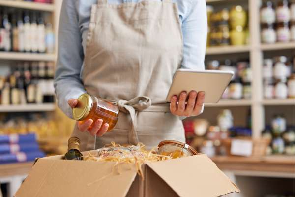 woman in retail holding tablet checking products package image