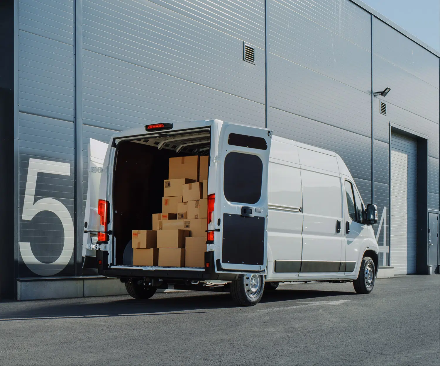 van with back doors open full of boxes image