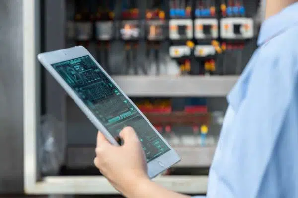 utilities person on tablet grid monitoring image