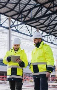 two workman in hi-vis on tablet image
