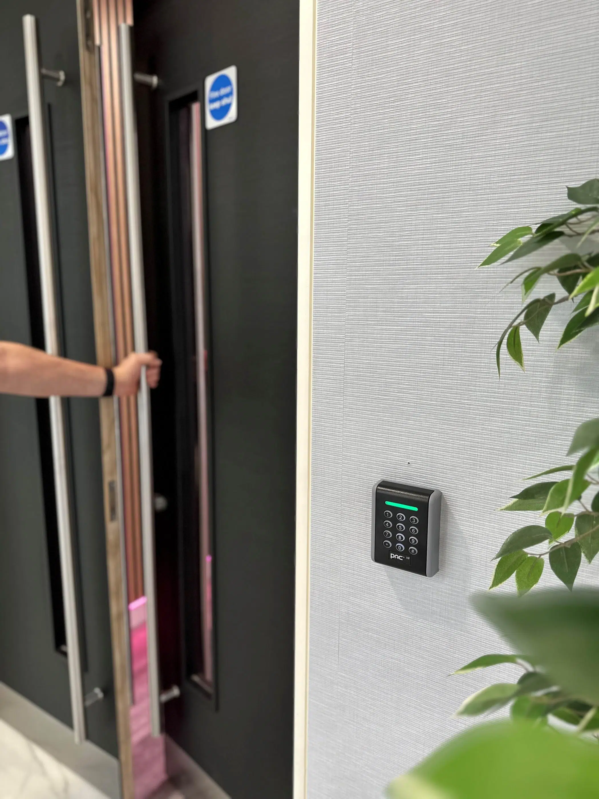 Person opening door by smart key pad image