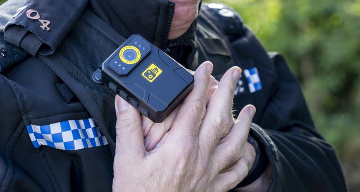 UK police officer putting his body camera on image