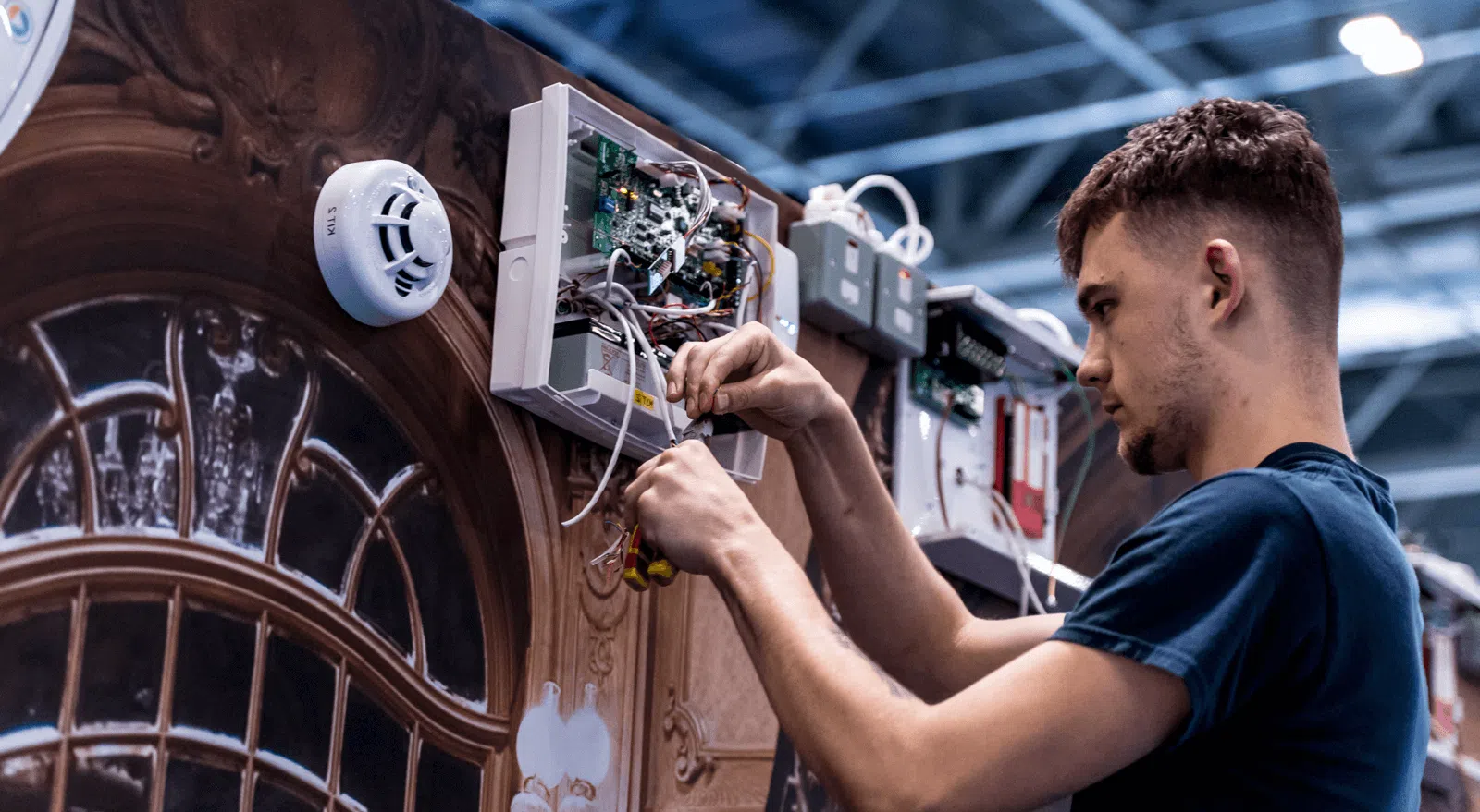 man wiring alarms panel image