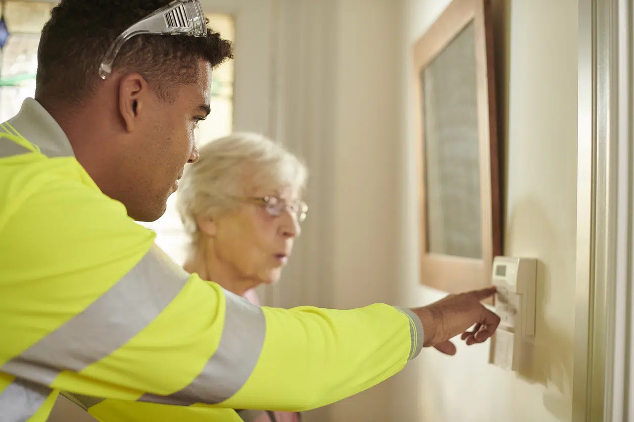 senior woman being shown how to use burglar alarm image