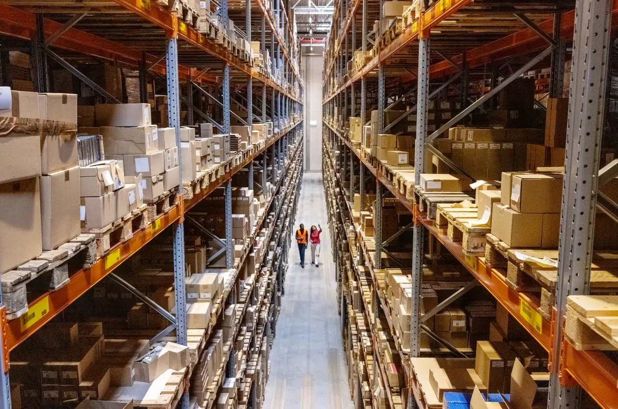 High view of warehouse manager walking with foremen checking stock image