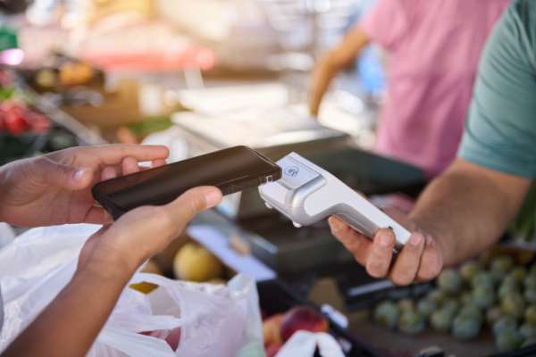 Person paying with mobile phone in shop image