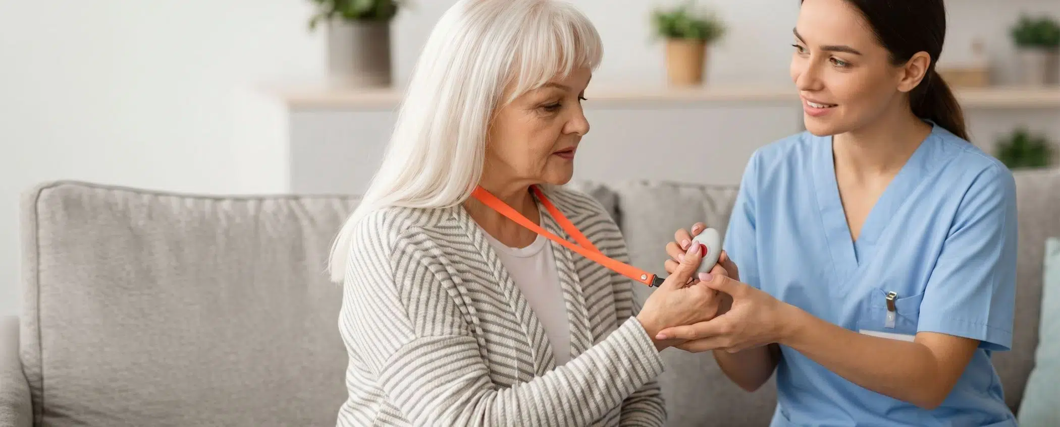 Care provider assisting an elderly person with a connected health monitoring device at home