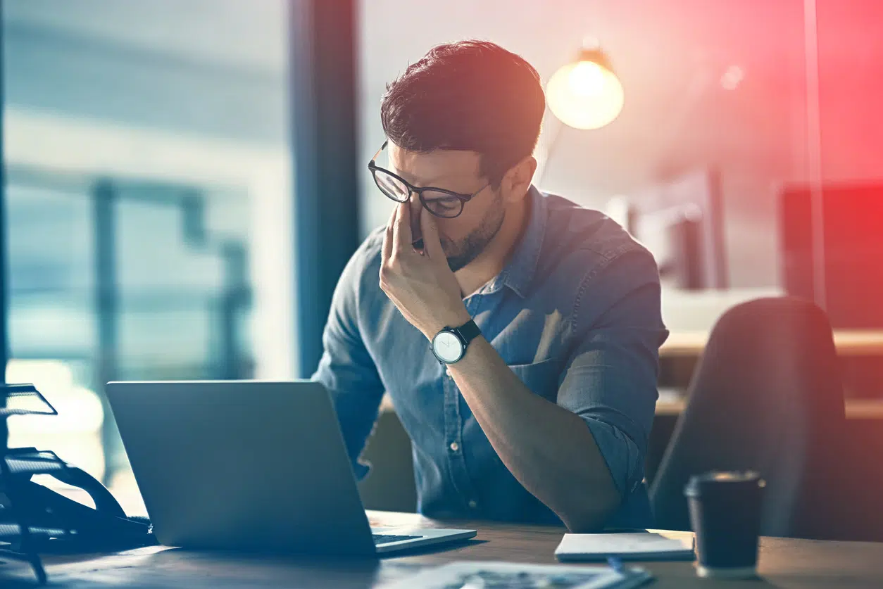 IT Expert sat at desk - frustrated with network downtime issues