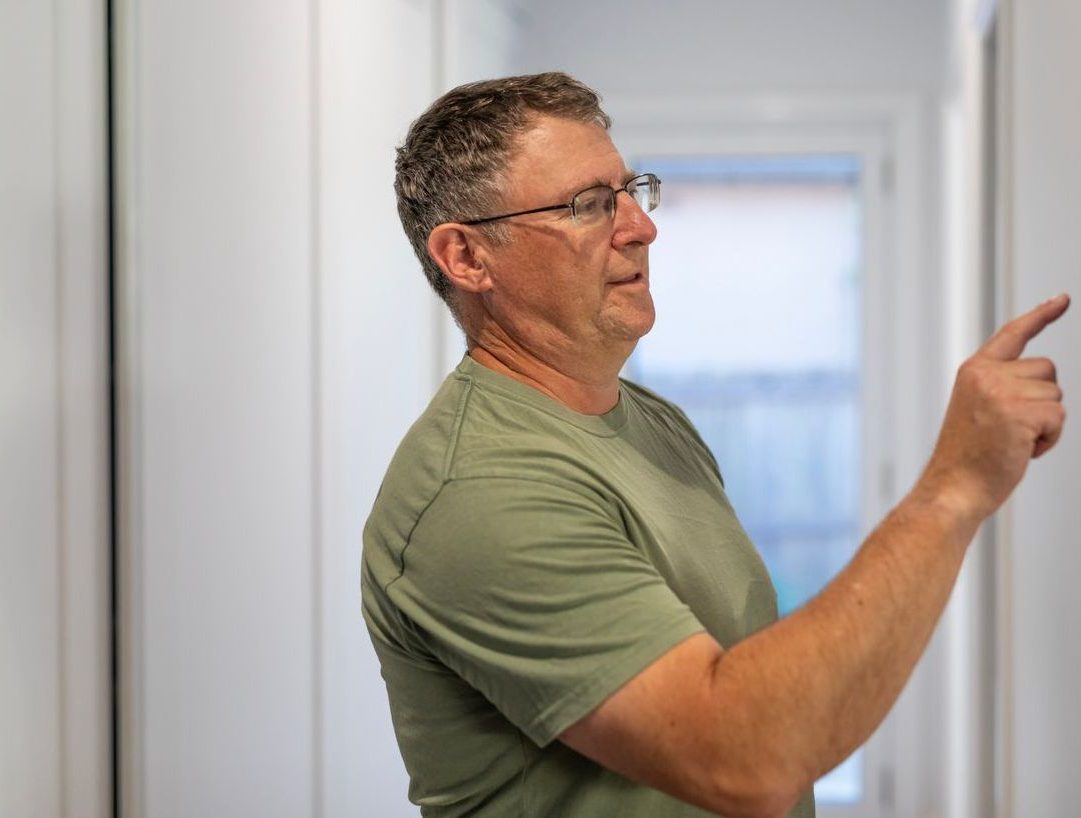 Man Using a Control Pad on a Smart Home - BT Redcare closure alternative
